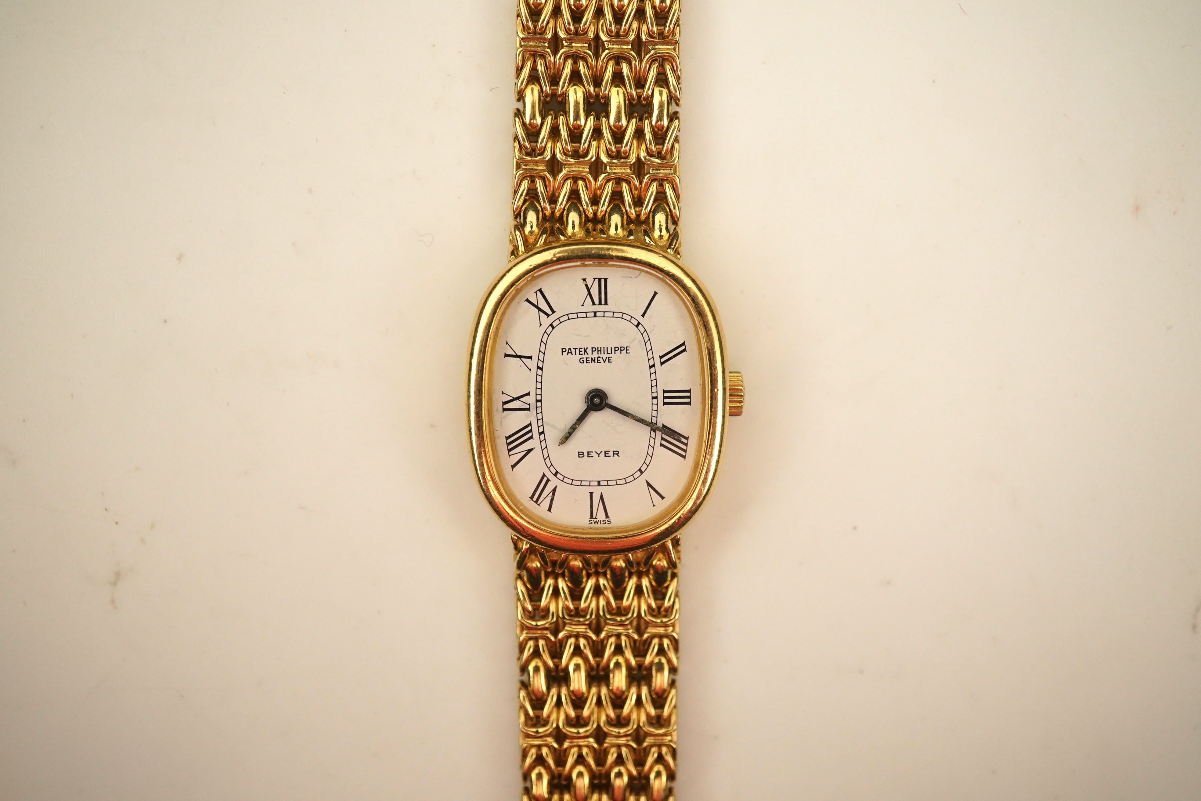 A lady's 18ct gold Patek Philippe manual wind wrist watch, on an integral 18ct gold Patek Philippe bracelet